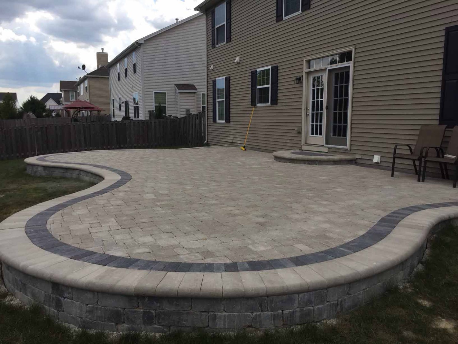 Raised paver patio and seat wall by Durane’s Landscaping